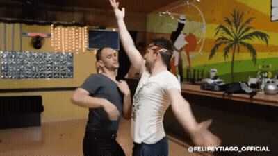 Two Men Dancing In Front Of Palm Tree Wall Felipeytiago Official GIF