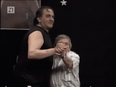 Two Men Dancing In Front Of Screen With Number 21 GIF