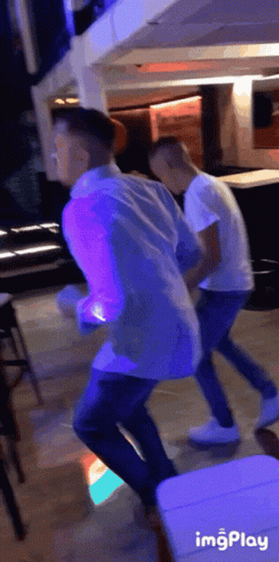 Two Men Dancing In Purple Light GIF