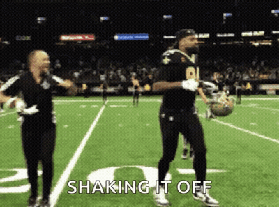 Two Men Dancing On Football Field Saying Shaking It Off GIF