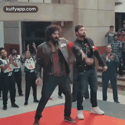 Two Men Dancing On Red Carpet In Front Of Crowd GIF
