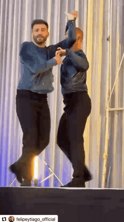 Two Men Dancing On Stage GIF
