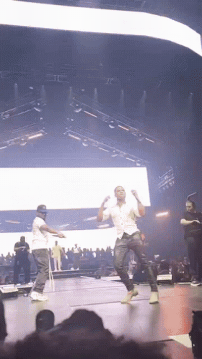 Two Men Dancing On Stage At Concert GIF