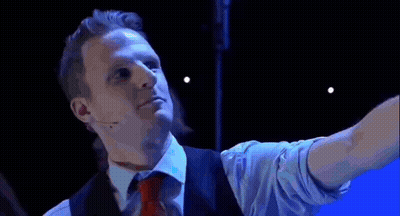 Two Men Dancing On Stage In Front Of Allow Screen GIF