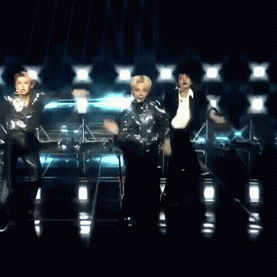 Two Men Dancing On Stage In Front Of Microphone GIF