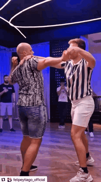 Two Men Dancing Together On Dance Floor GIF