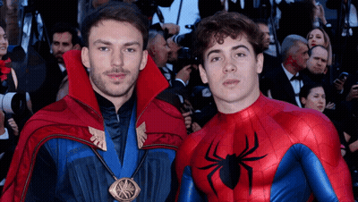 Two Men Dressed As Doctor Strange And Spider-Man Pose For A Picture GIF