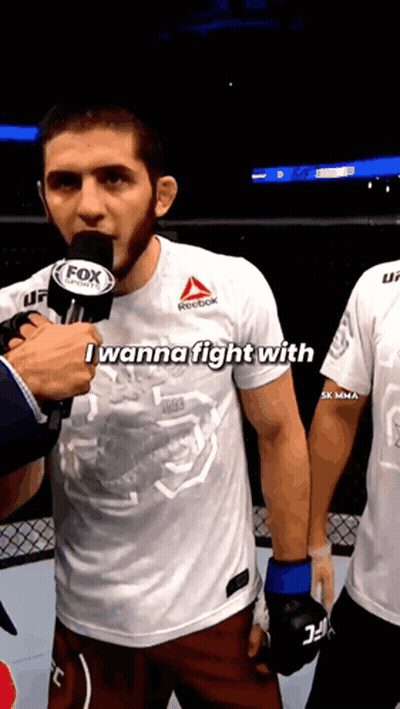 Two Men Drinking From Bottles In Front Of Phas Wall GIF