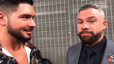 Two Men Facing Each Other With Pin Saying RN GIF