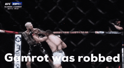 Two Men Fighting In A Cage With The Words Gamrot Was Robbed GIF