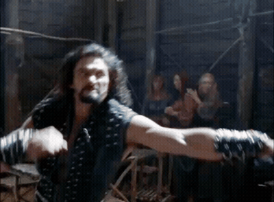 Two Men Fighting In A Room With Spectators GIF