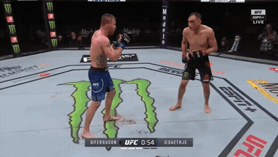 Two Men Fighting In A Ufc Ring With A Monster On The Ground GIF