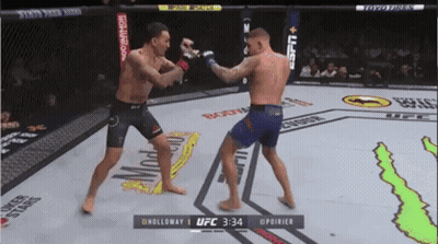 Two Men Fighting In Boxing Ring At 2:34 GIF