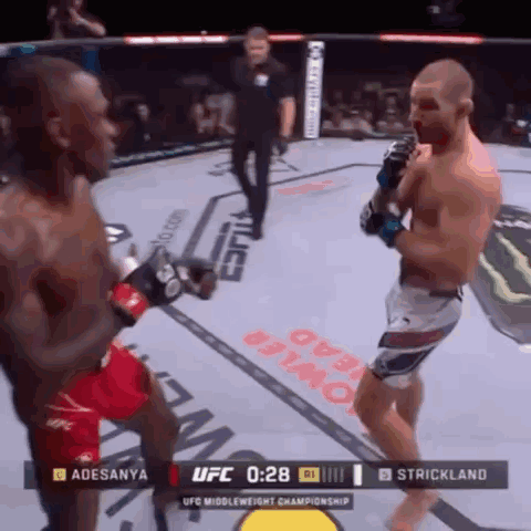 Two Men Fighting In Boxing Ring GIF
