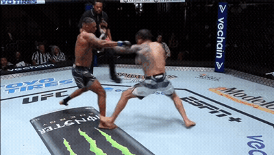 Two Men Fighting In Boxing Ring Sponsored By OYO Tires And Modelo GIF