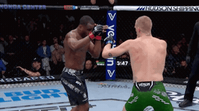 Two Men Fighting In Boxing Ring With Bud Light Sign GIF