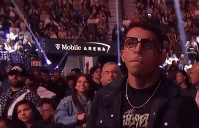 Two Men Fighting In Boxing Ring With Crowd Watching GIF