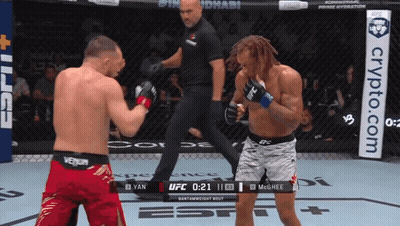 Two Men Fighting In Boxing Ring With Crypto.com Banner GIF
