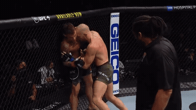 Two Men Fighting In Boxing Ring With Geico Sign GIF