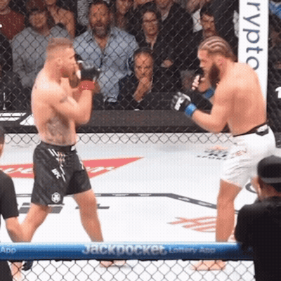 Two Men Fighting In Boxing Ring With Jackpot Banner GIF