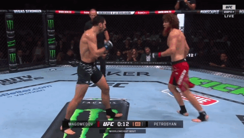 Two Men Fighting in Boxing Ring with Monster Energy Logo