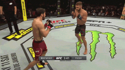 Two Men Fighting In Boxing Ring With Monster On Floor GIF
