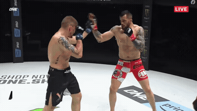 Two Men Fighting In Boxing Ring With One Shorts GIF