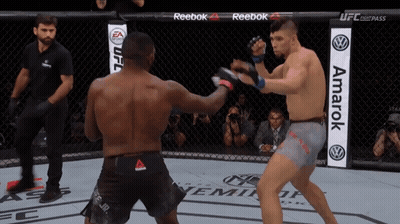 Two Men Fighting In Boxing Ring With Reebok And Amarak Banners GIF