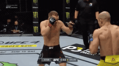 Two Men Fighting In Boxing Ring With Referee GIF