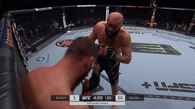 Two Men Fighting In Boxing Ring With Scoreboard Saying Significant Strikes GIF