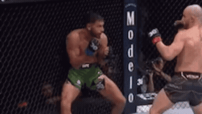 Two Men Fighting In Boxing Ring With Sign GIF