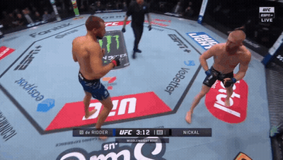 Two Men Fighting In Boxing Ring With UFC 3:12 Clock GIF