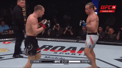 Two Men Fighting In Boxing Ring With UFC Logo GIF