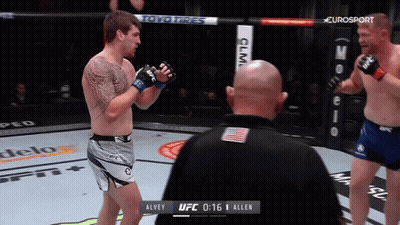 Two Men Fighting In Boxing Ring With UFC GIF
