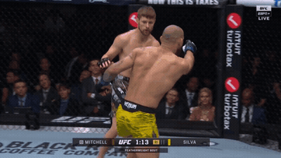 Two Men Fighting In Boxing Ring With Venum Belt GIF