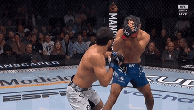 Two Men Fighting In Cage Before Crowd GIF