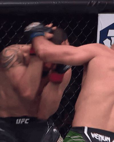 Two Men Fighting In Cage One Wearing UFC Shorts GIF