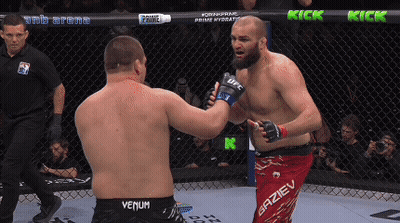 Two Men Fighting In Cage One Wearing Venum Shorts GIF