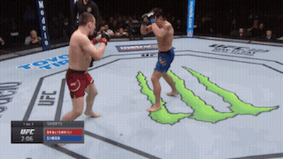 Two Men Fighting In Cage With Dial Law Sign GIF