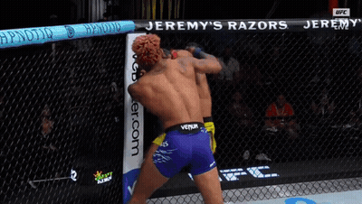 Two Men Fighting In Cage With Jeremy's Razors GIF