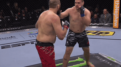 Two Men Fighting In Cage With Monster Energy Ad GIF