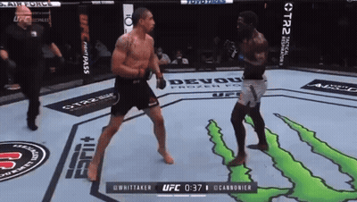 Two Men Fighting In Cage With Referee GIF