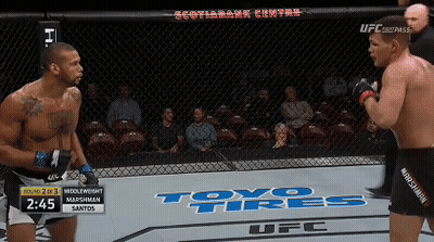 Two Men Fighting In Cage With Toyo Tires On Floor GIF
