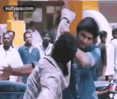 Two Men Fighting In Crowd On Street GIF