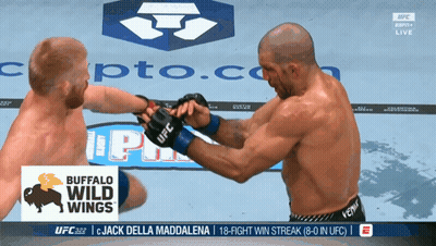 Two Men Fighting In Front Of Buffalo Wild Wings Banner GIF