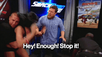 Two Men Fighting In Front Of Smackdown Sign GIF