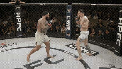 Two Men Fighting In Ring With Crnr Banner GIF