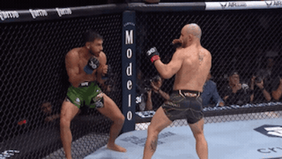 Two Men Fighting In Ring With Modelo Sign GIF