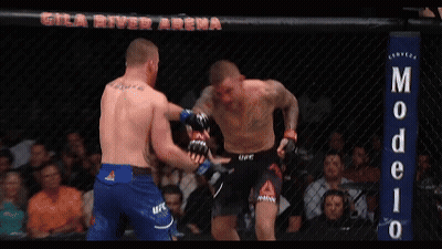 Two Men Fighting In Ring With Modelo Sign GIF