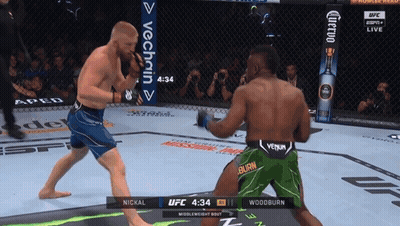 Two Men Fighting In UFC Match One Wearing Green Shorts With Burn GIF